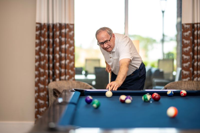 man playing billiards 